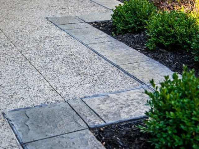 Stamped concrete borders at the edge of driveway that provides the look of natural store