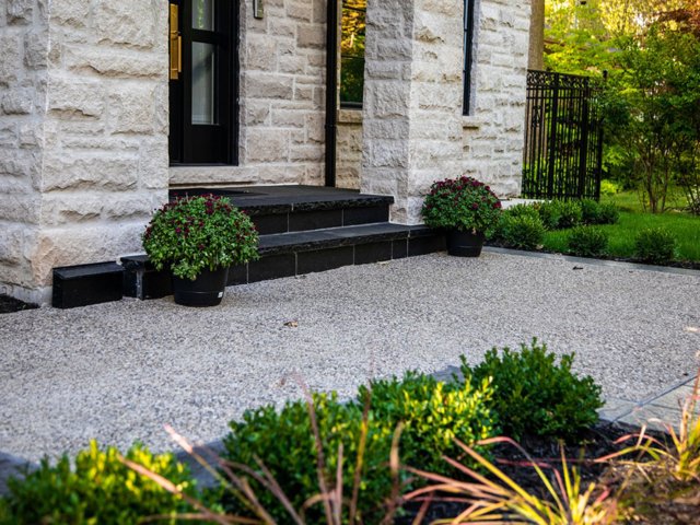 Front entrance with jet black pavers in a wet lay application, and set in concrete with mortared joints